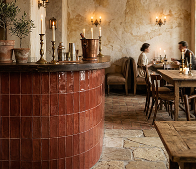 ShuangOu glossy red strip tiles on a curved bar counter in a rustic restaurant interior