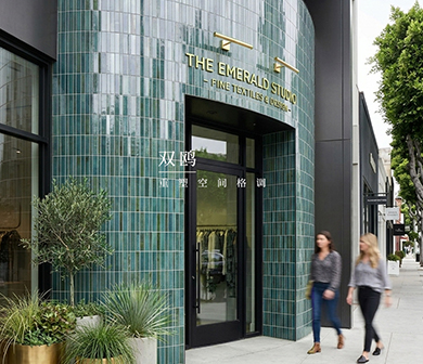 ShuangOu green strip tiles cladding a commercial storefront facade with gold signage