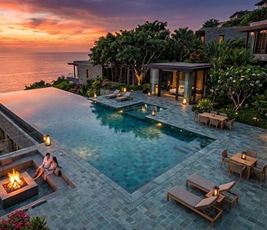 ShuangOu pool tiles in a cliffside infinity pool overlooking the ocean at sunset with a fire pit and sun loungers