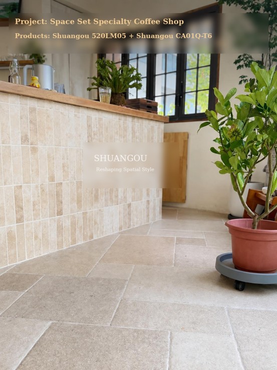Interior view of a coffee shop showing a bar counter with Shuangou travertine handmade bricks (520LM05) and soft beige limestone floor tiles (CA01Q-T6) beside green plants.